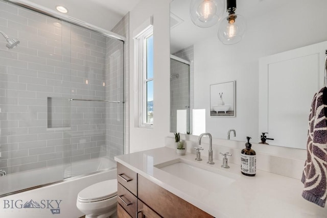 full bathroom with toilet, vanity, and shower / bath combination with glass door