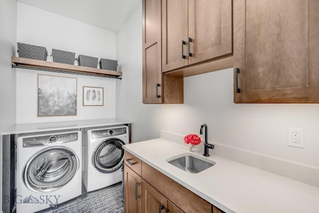 washroom with sink, separate washer and dryer, and cabinets