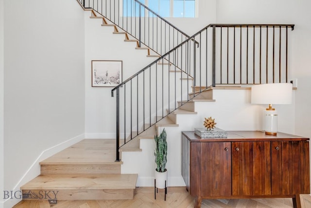 stairway with hardwood / wood-style floors