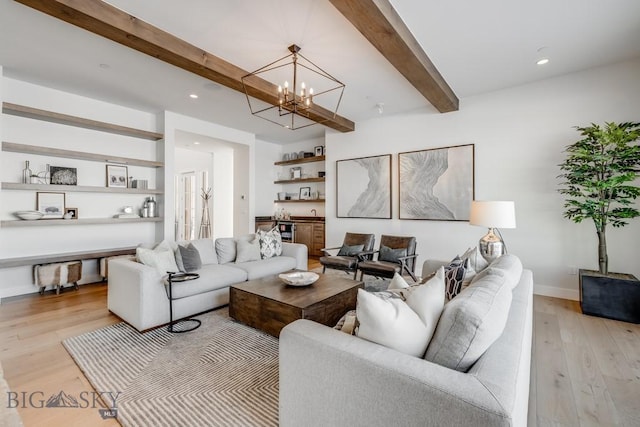 living room featuring light wood-type flooring, an inviting chandelier, and beamed ceiling