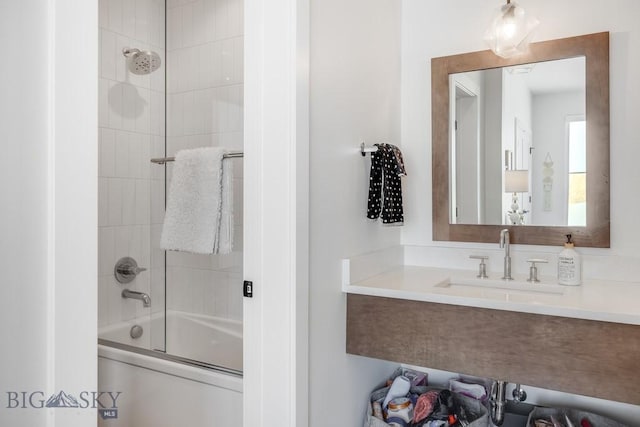 bathroom with vanity and combined bath / shower with glass door