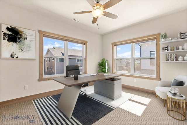 office space with ceiling fan and plenty of natural light