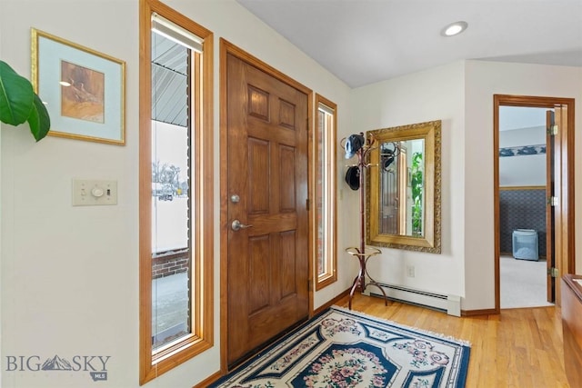 entrance foyer with light wood finished floors, baseboards, baseboard heating, and recessed lighting