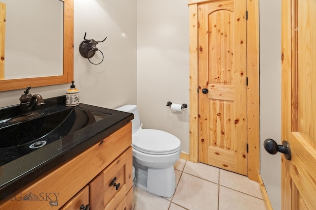 half bath featuring tile patterned flooring, toilet, and vanity