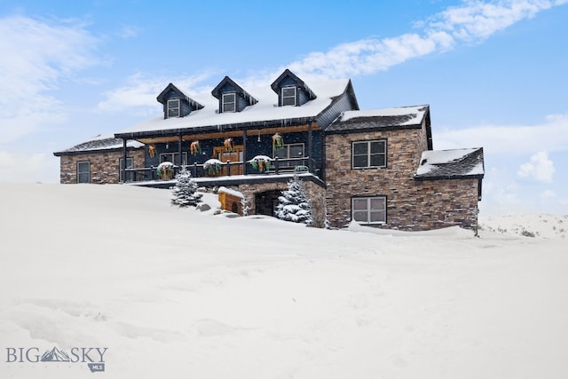 view of front of property with a porch and stone siding