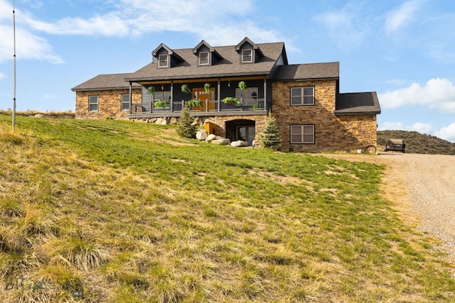 view of front of property featuring stone siding and a front yard