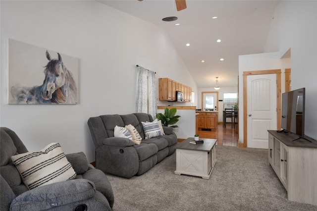 living area featuring high vaulted ceiling, recessed lighting, a ceiling fan, and light colored carpet