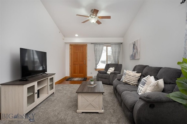 living room with wood finished floors, vaulted ceiling, baseboards, and ceiling fan