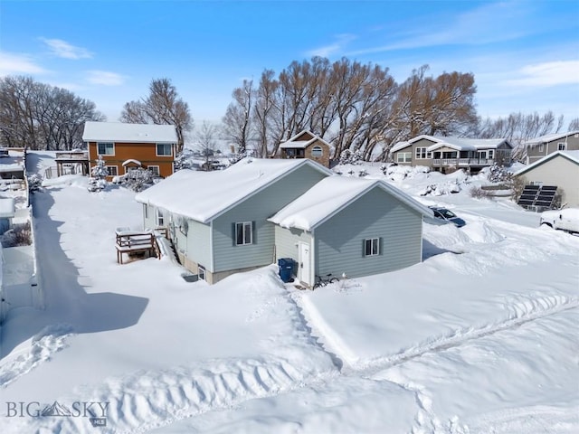 snowy aerial view featuring a residential view