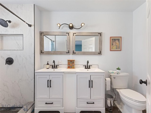 bathroom featuring toilet, double vanity, a sink, and a marble finish shower