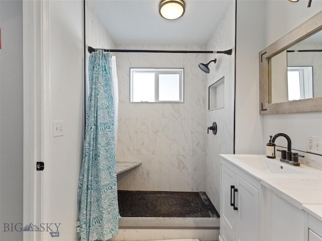 full bathroom featuring a shower stall and vanity