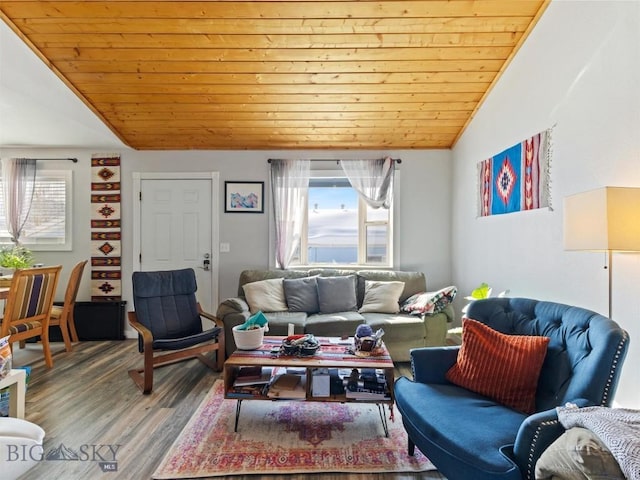 living area featuring vaulted ceiling, wood ceiling, plenty of natural light, and wood finished floors