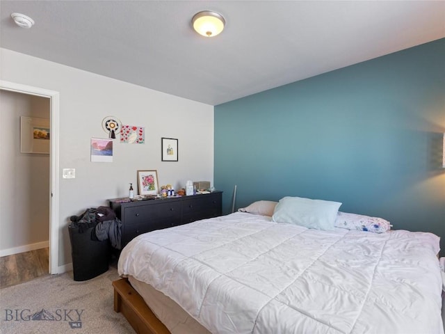 bedroom featuring carpet and baseboards