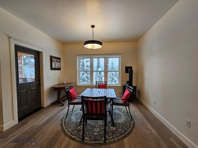 dining room featuring dark wood-type flooring and baseboards