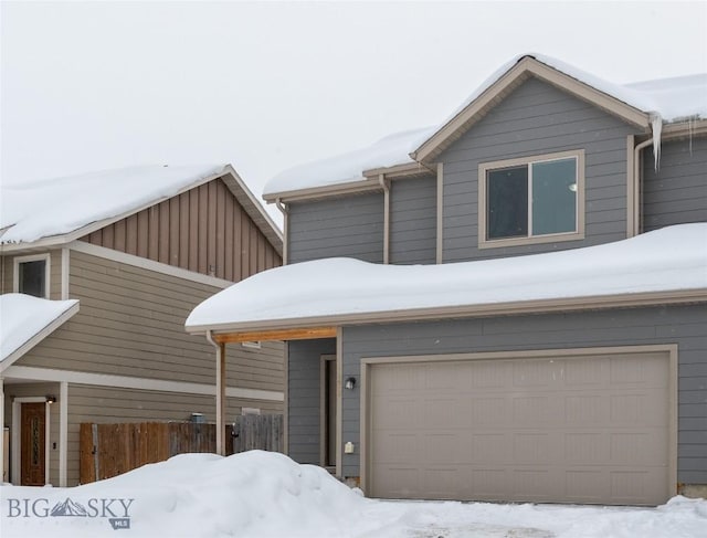 view of front of home with an attached garage and fence