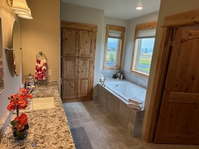 full bathroom featuring double vanity and a garden tub