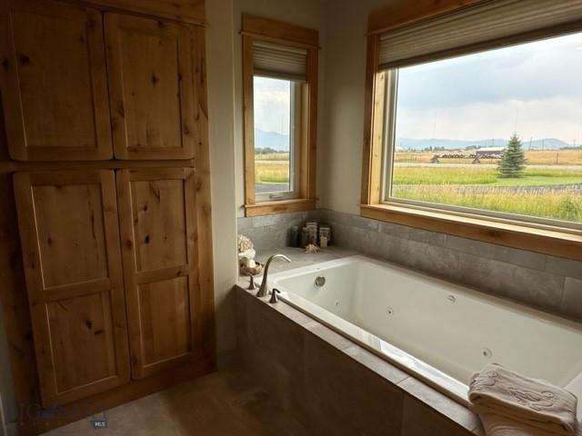 bathroom featuring a tub with jets