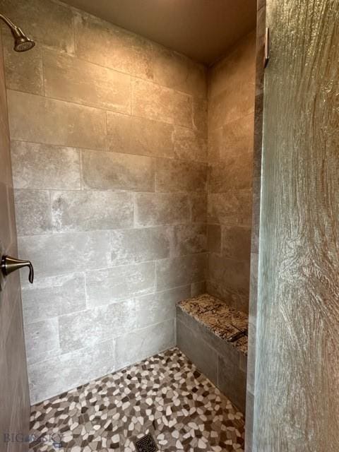 bathroom with tiled shower