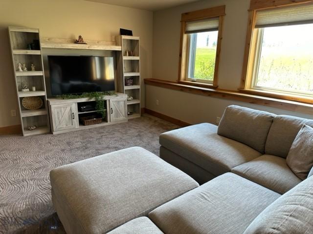 carpeted living area with baseboards