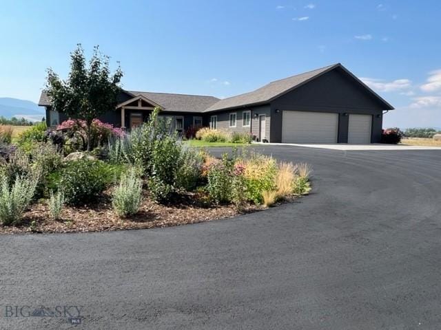 ranch-style house featuring driveway and an attached garage