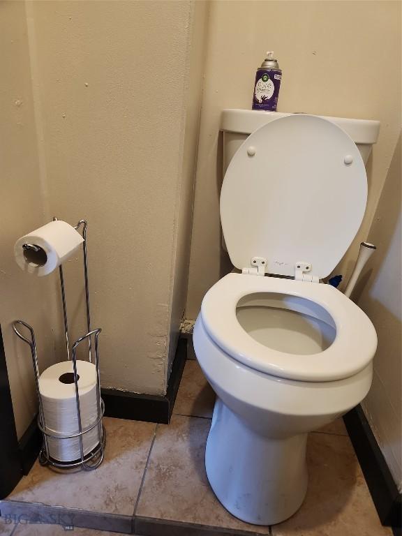 bathroom with toilet and tile patterned flooring