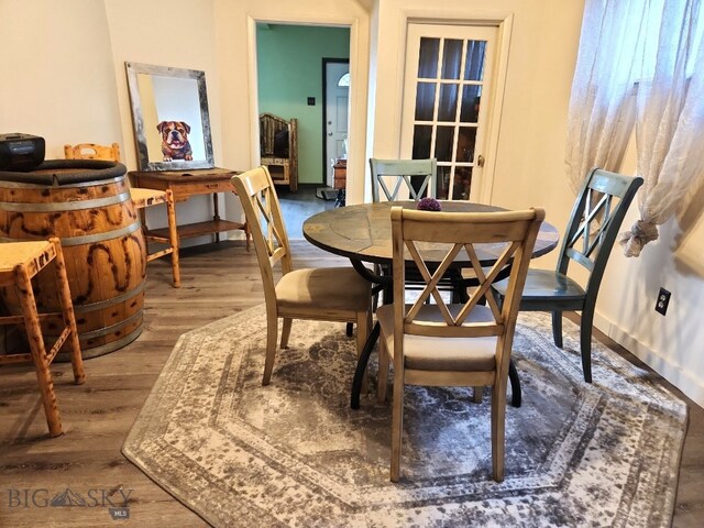 dining area with wood finished floors and baseboards