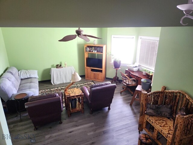 living area featuring a ceiling fan and wood finished floors