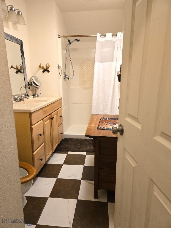 bathroom featuring tile patterned floors, toilet, vanity, and a shower with shower curtain