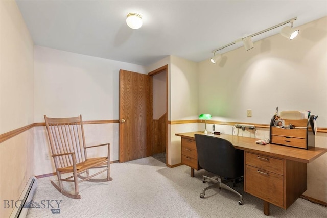 home office with rail lighting, baseboard heating, and light colored carpet