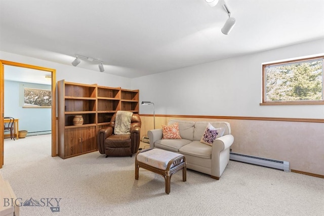 living room featuring light carpet, baseboard heating, a baseboard radiator, and track lighting