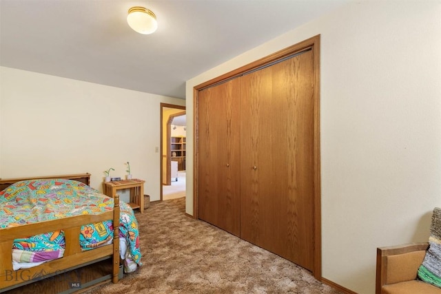 carpeted bedroom with a closet