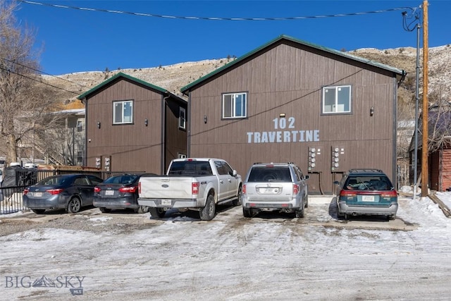 view of front of property featuring uncovered parking and a mountain view