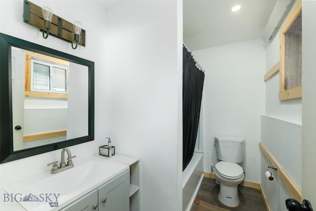 102 Travertine St, Gardiner, MT 59030 - bathroom with toilet, wood finished floors, vanity, baseboards, and shower / bath combo with shower curtain