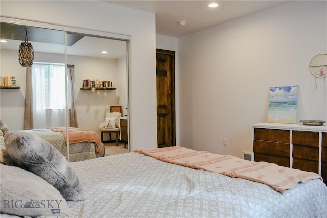 carpeted bedroom with a closet, visible vents, and recessed lighting