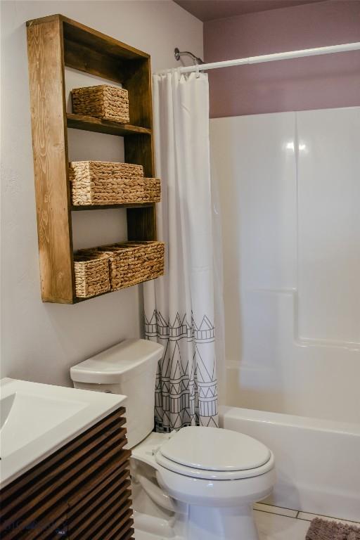 bathroom featuring vanity, tile patterned flooring, shower / bath combination with curtain, and toilet