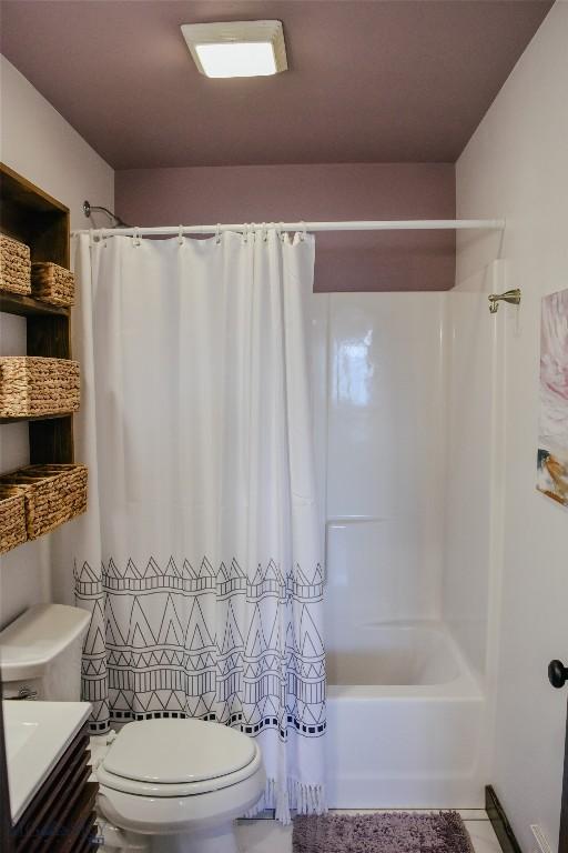 full bathroom with shower / tub combo, vanity, toilet, and tile patterned floors