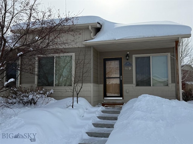 view of snow covered property entrance