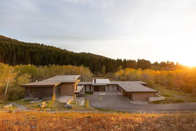 exterior space with a wooded view