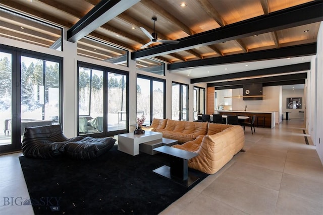 living room featuring ceiling fan, beamed ceiling, and light tile patterned floors