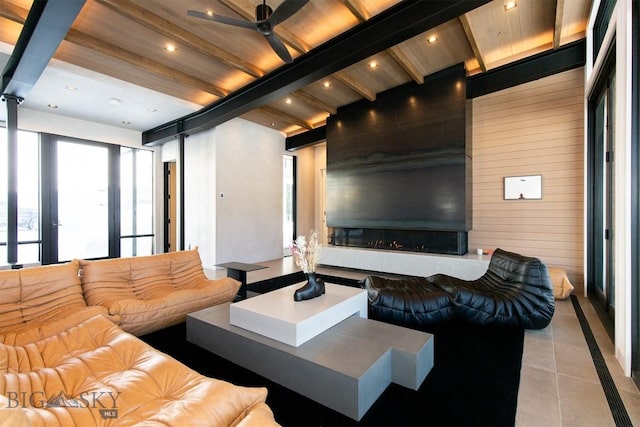 living area featuring recessed lighting, beamed ceiling, and light tile patterned flooring