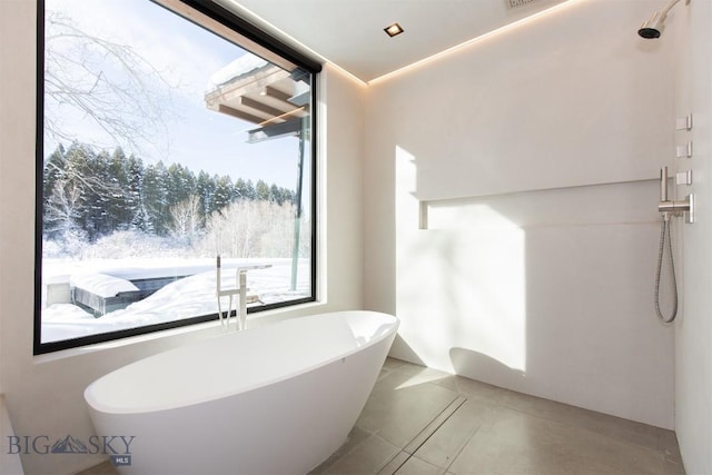 full bathroom featuring a soaking tub, tile patterned flooring, and walk in shower