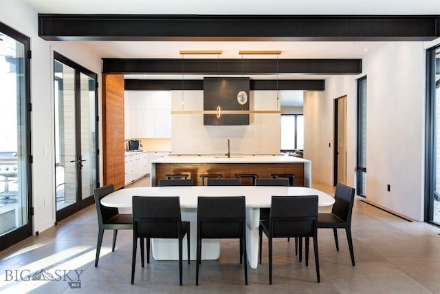 kitchen with a center island, white cabinets, light countertops, and modern cabinets