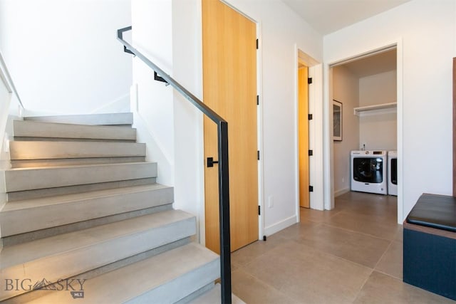 stairs featuring washer and clothes dryer and tile patterned floors