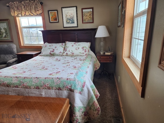 carpeted bedroom featuring visible vents and baseboards