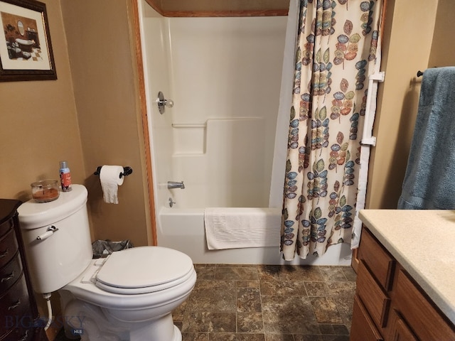 full bath featuring toilet, stone finish flooring, shower / bath combination with curtain, and vanity