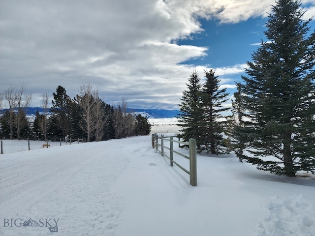 snowy yard featuring a mountain view