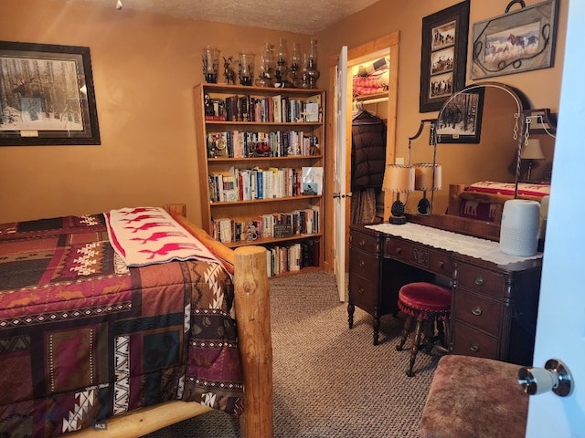 carpeted bedroom with a textured ceiling