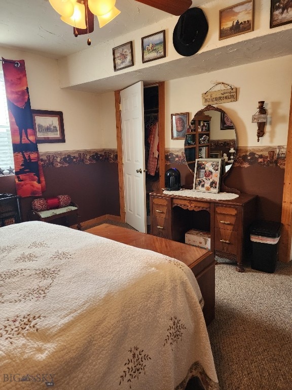 carpeted bedroom featuring a wainscoted wall