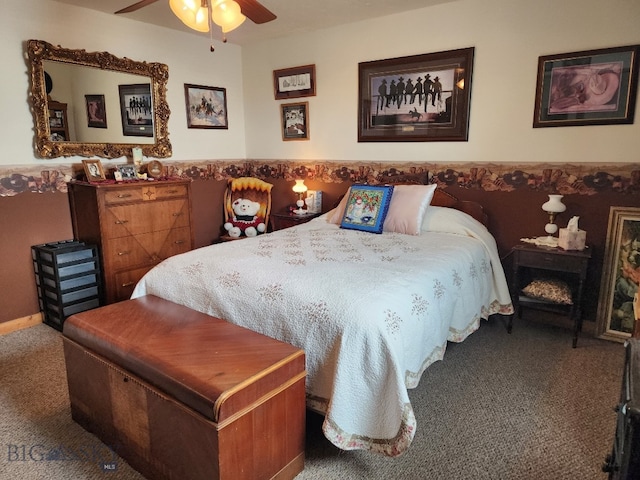 bedroom with wainscoting, carpet, and a ceiling fan