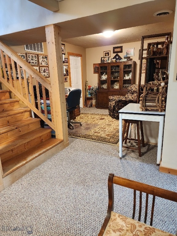 interior space with carpet floors and visible vents